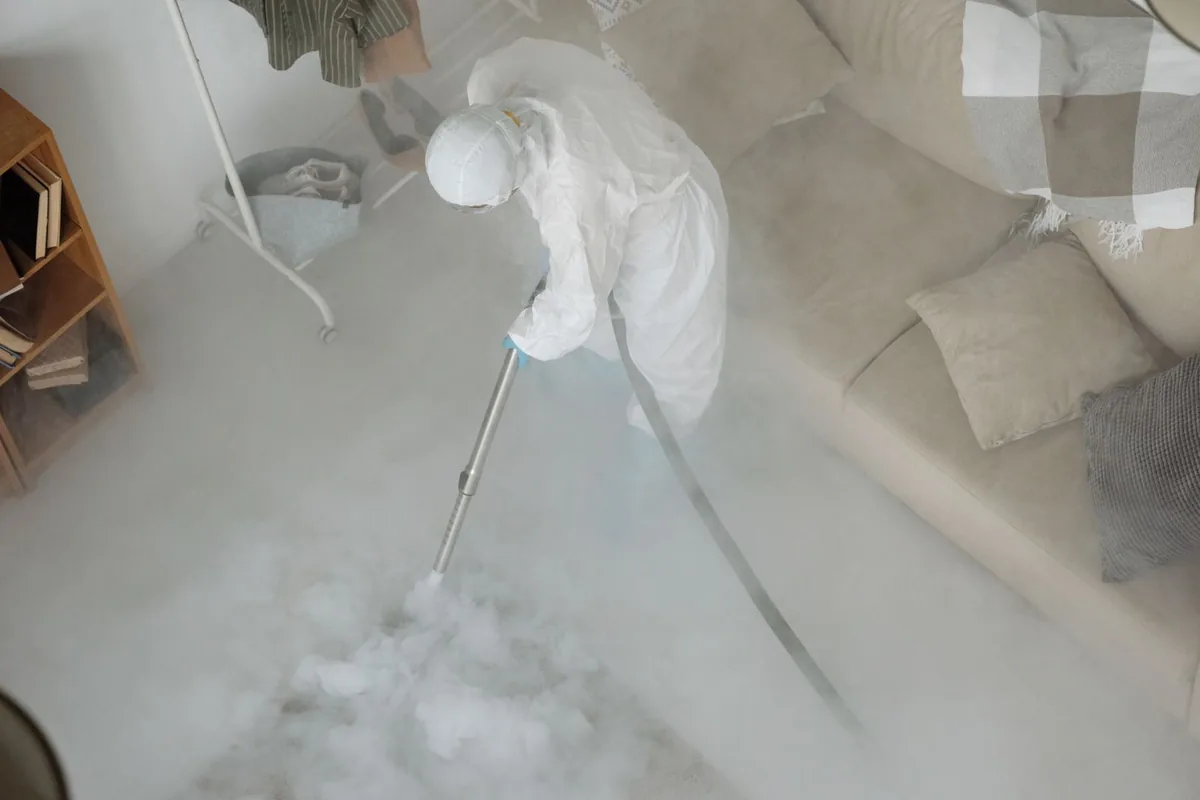 Biohazard cleanup technician in protective equipment, Schulenburg, TX